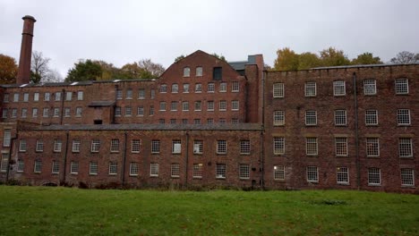 tracking shot of quarry bank mill on a cloudy day