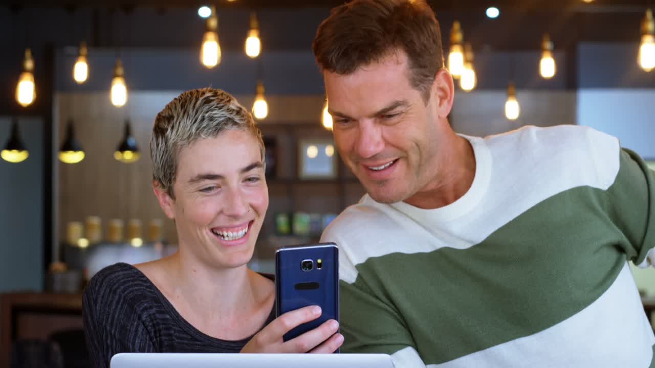 Executive discussing on mobile phone in office cafeteria 4k