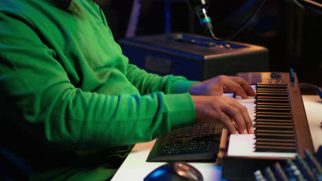 young songwriter playing piano and singing on microphone