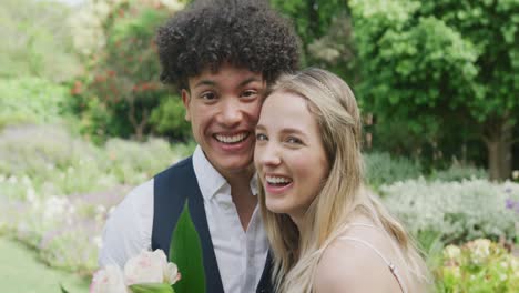 retrato de una feliz pareja diversa en un día soleado en la boda