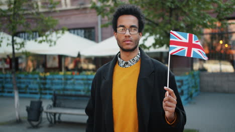 man holding uk flag in city