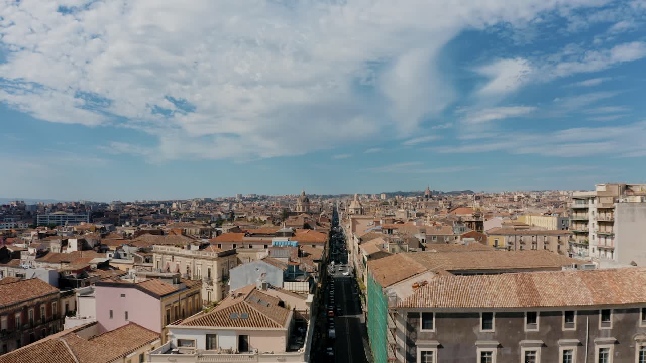 Aerial view over the rooftops in Sicily. Catania historical city street from a birds eye view. Flying forward.
