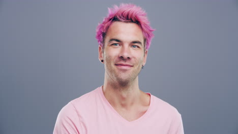 man with pink hair showing thumbs up