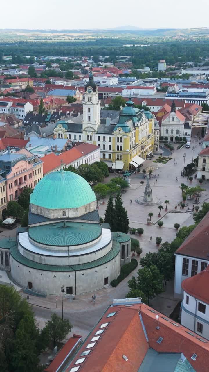 Flying toward Széchenyi Square in Pécs, highlighting the mosque and surrounding urban architecture