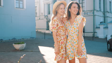 two women friends in floral dresses