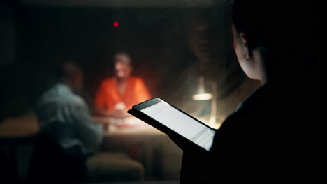 interrogation scene with tablet