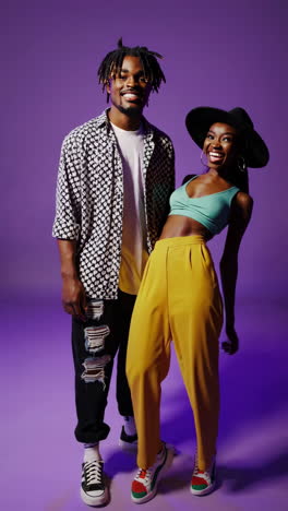 stylish young adults posing and interacting on a vibrant purple studio background