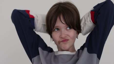 young boy with chocolate on his face smiling with hands behind head