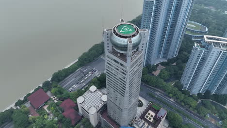 drone view of helicopter pad helipad on the roof of a skyscraper landmark building in downtown with cityscape view on sunny day