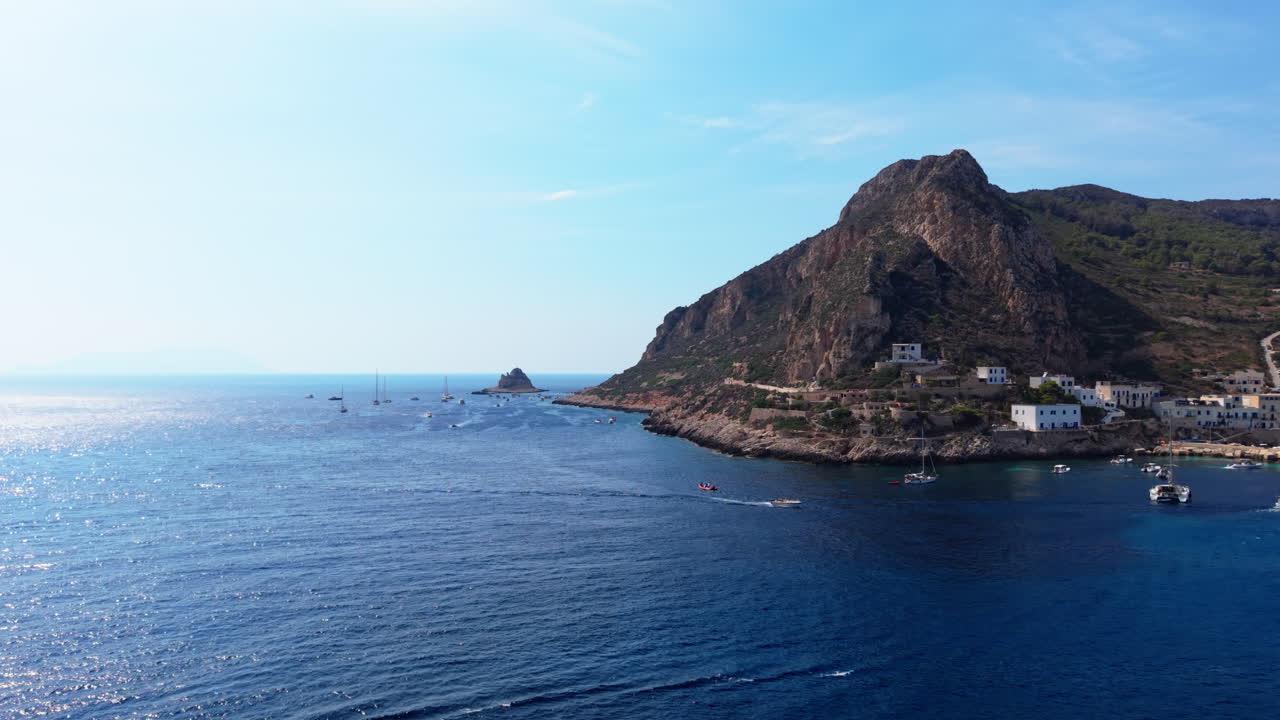 Peaceful Sicily coast with boats, sunny weather, and clear sea views