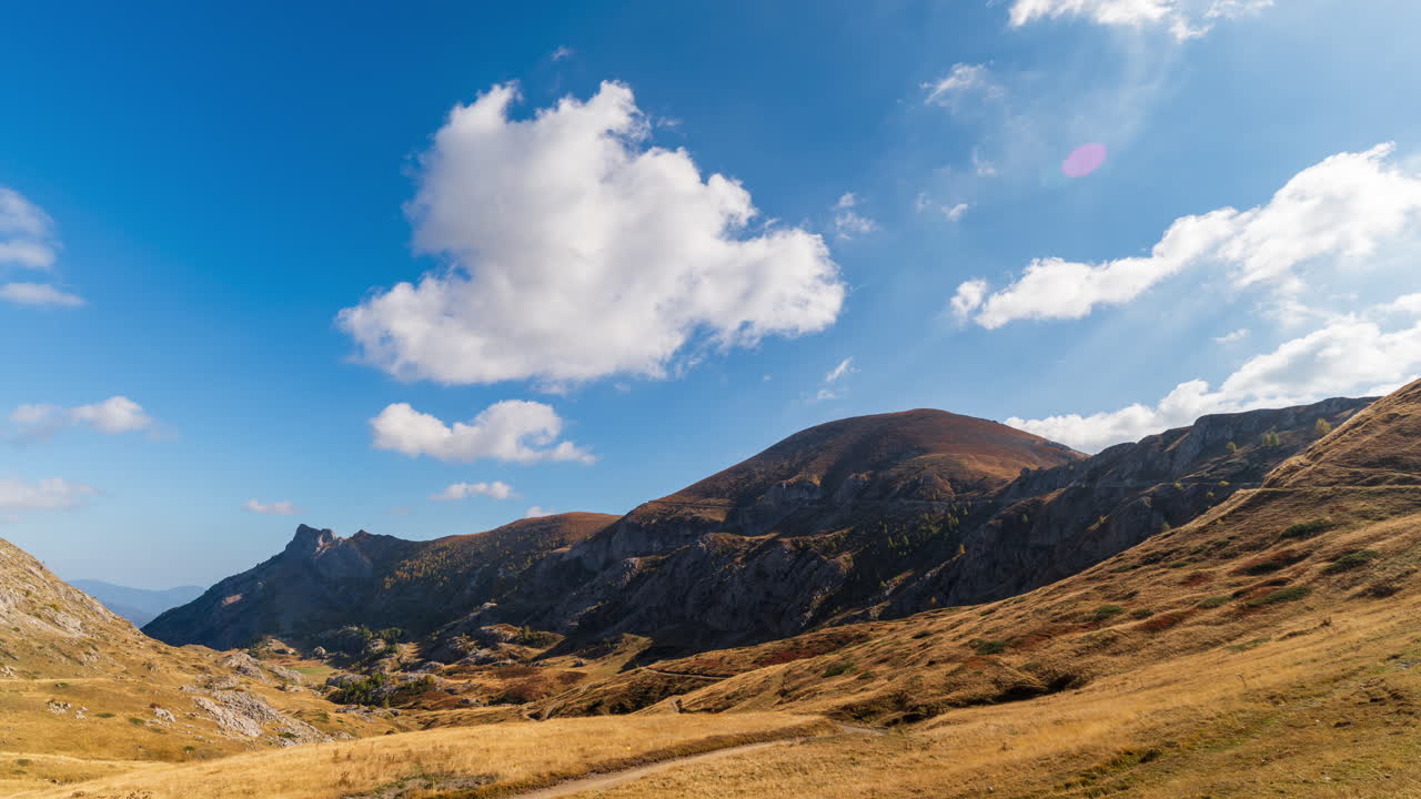 Majestic Italian Alps in day timelapse with clear sky and rolling clouds