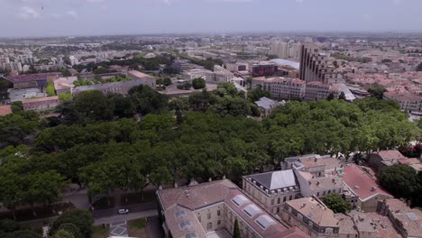 Rotating-aerial-shot-of-the-park-where-people-are-playing-sports-at-the-Olympic-Games,-Montpellier