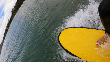 pov first person view of surfer surfing on foam board