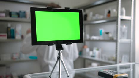 green screen tablet pc indoor of pharmacy with pharmacist, checking goods