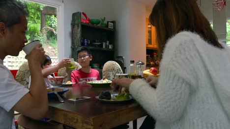 family members having juice on dining table 4k