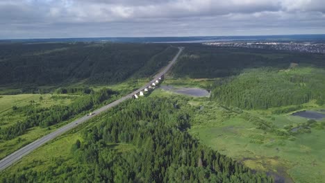 aerial view of highway bridge over landscape with forest and river