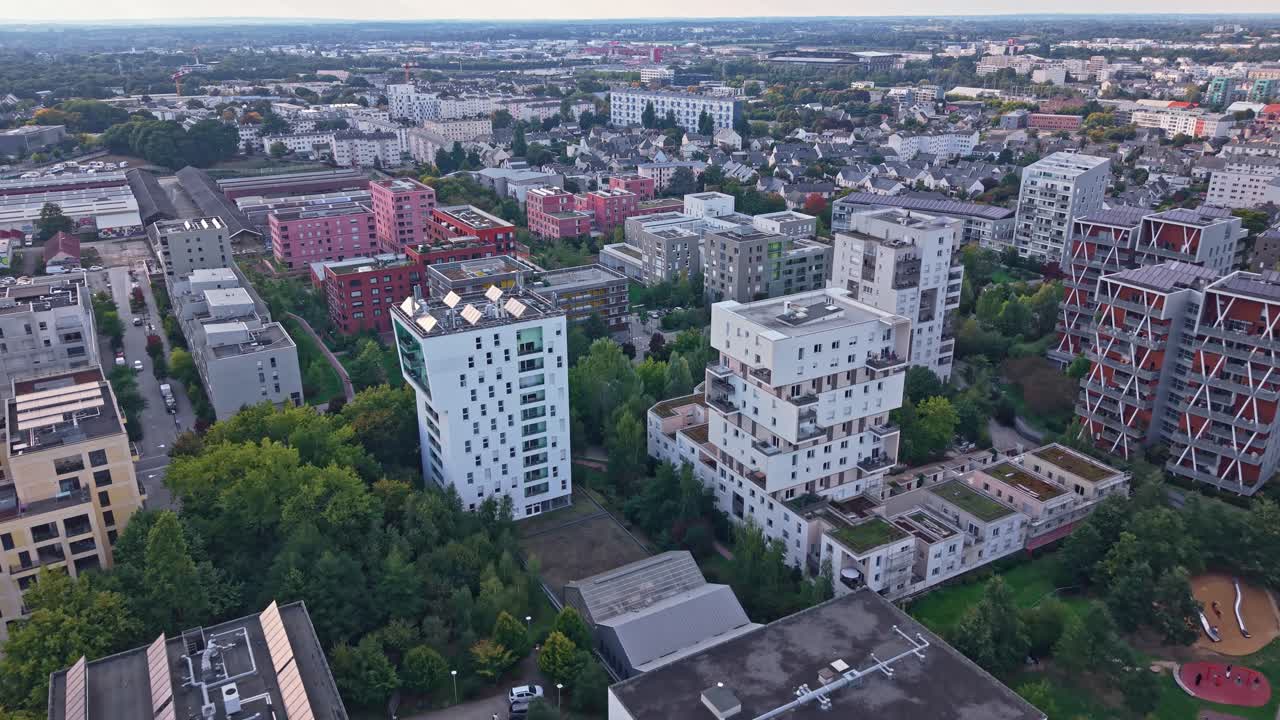 Forward drone fly at La Courrouze metropolitan district with residential blocks in natural green environment, Rennes, Ille-et-Vilaine, France