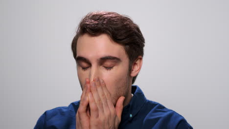 sick man sneezing on light background. student sneezing from allergy