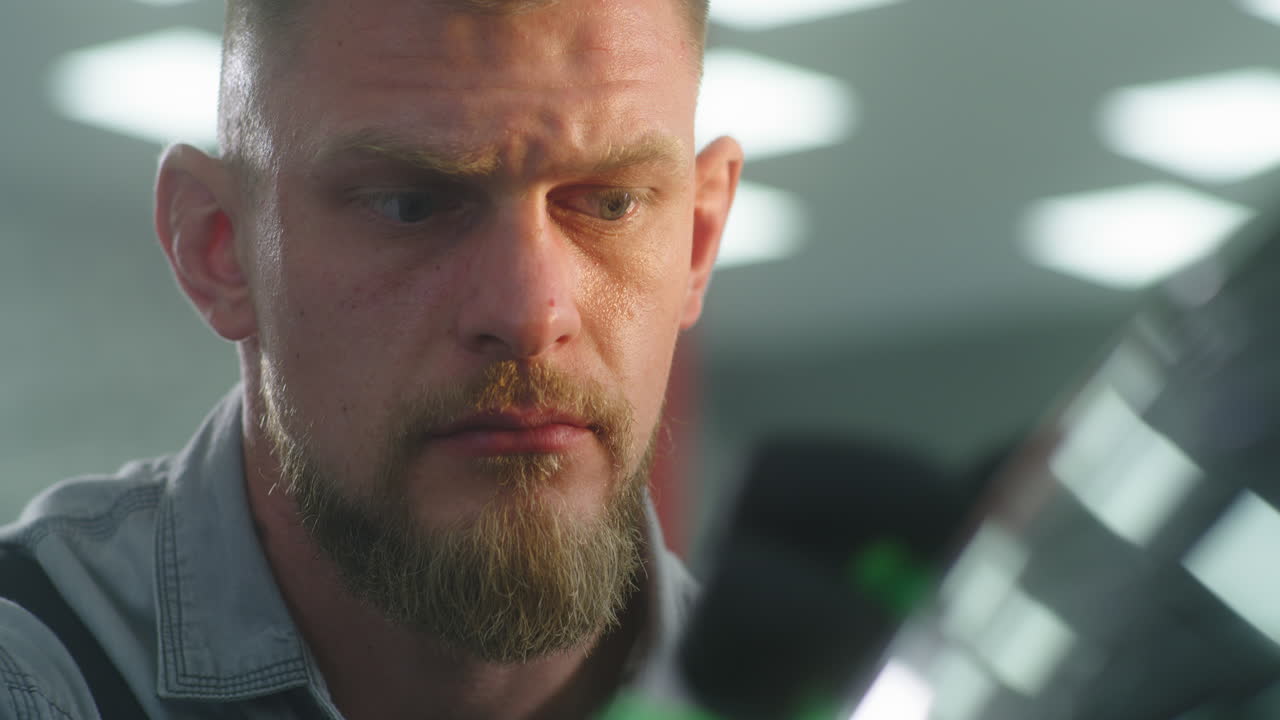 Mechanic Inspecting a Car Part