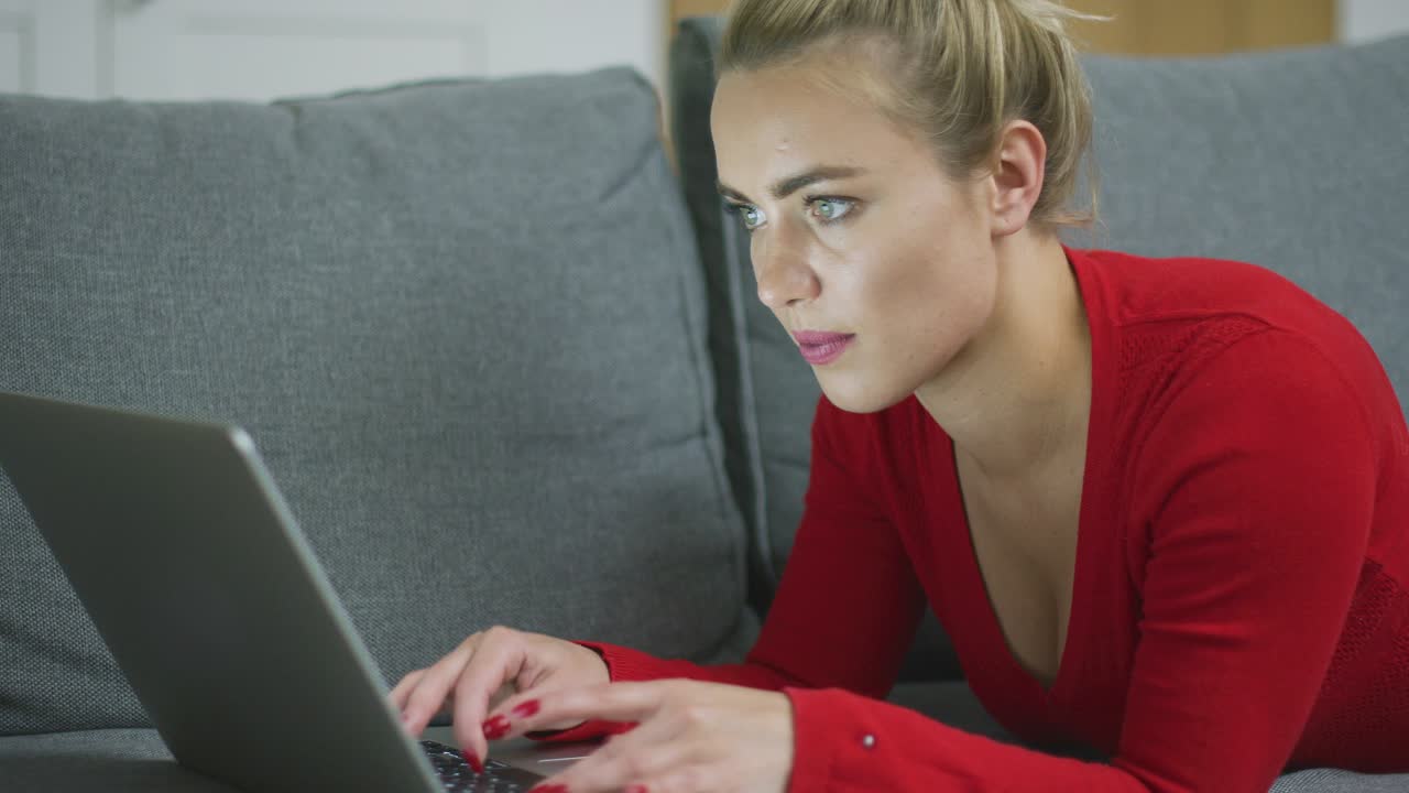 Concentrated woman typing on laptop