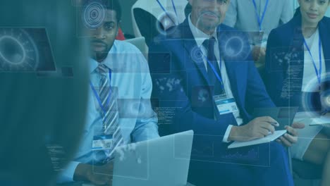 animation of processing circles on digital screens over diverse businesspeople during meeting