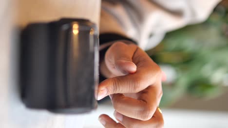 close-up of a hand touching a dark object