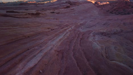 Gimbal-booming-up-and-rolling-focus-shot-of-the-sandstone-Fire-Wave-in-Valley-of-Fire,-Nevada