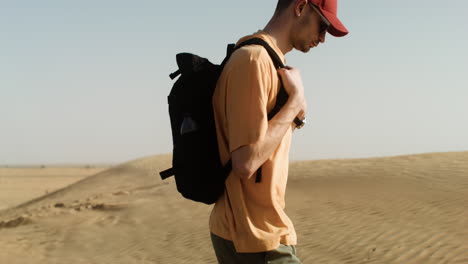 male adventurer crossing the desert