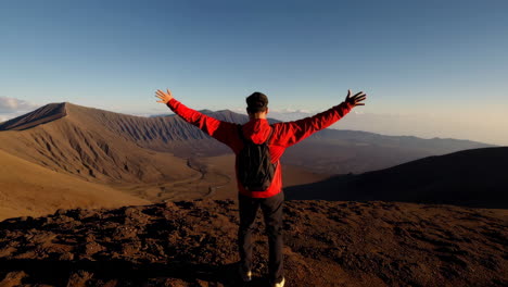 triumphant hiker overlooking a vast mountain landscape