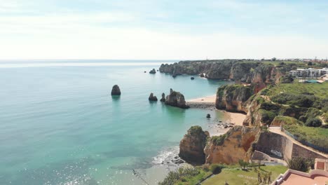 Magnificent-landscape-of-Eroded-Shoreline-of-Lagos,-near-Estudante-Beach,-Algarve,-Portugal---Aerial-Fly-back-wide-shot