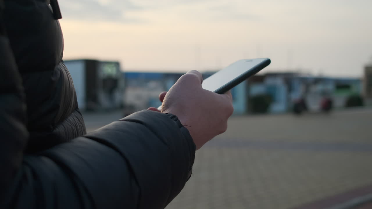 человек, использующий смартфон на открытом воздухе