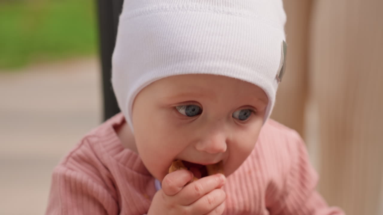 Baby Snacks Outdoors, Child Exploring Outdoors Happily, Infant Delightfully Savoring Snack In Open Air Setting, Curious Young Child Exploring Outdoors While Enjoying Tasty Snack In Nature