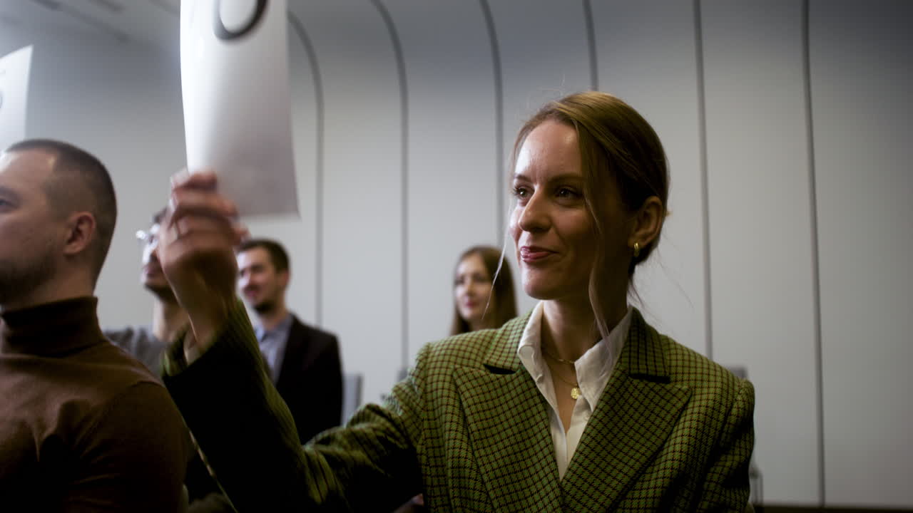 Woman holding up number 28