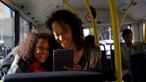 commuters using digital tablet while travelling in bus 4k