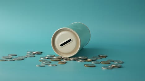 empty piggy bank with scattered coins