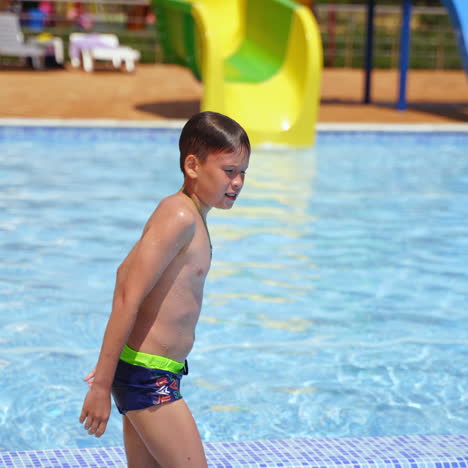 boy in the swimming pool. teenage boy jumping underwater outdoors. happy childhood. summer vacation near the pool.