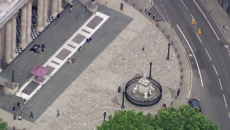 zoom out shot showing people standing outside the famous st pauls cathedral