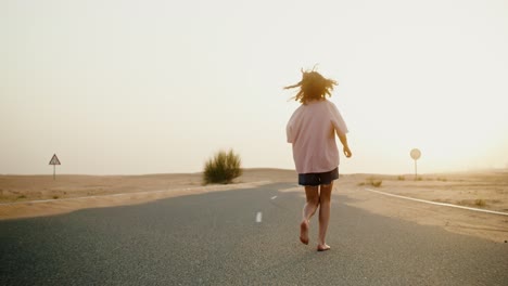 woman running in desert road at sunrise/sunset