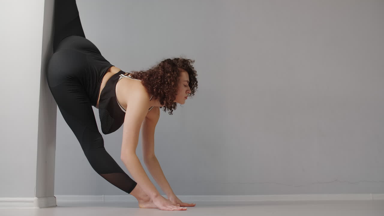 Woman Stretching against a Wall