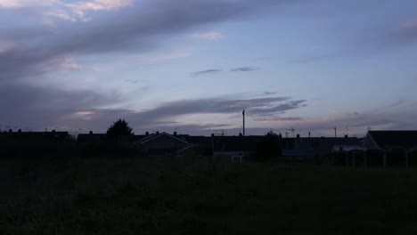 Timelapse-of-clouds-at-sunset-over-urban-neighborhood