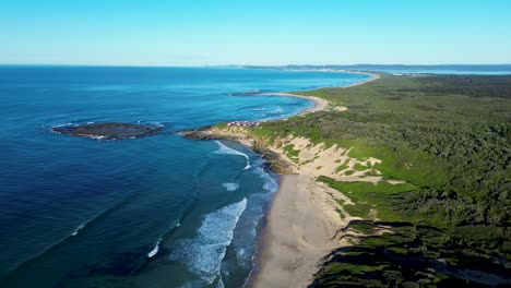 Drone-aerial-landscape-view-of-Soldiers-Beach-Norah-Head-ocean-sand-dunes-headland-bush-forest-rural-town-suburbs-Central-Coast-tourism-travel