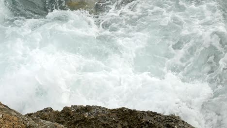 waves beating on the rocks on the beach in montenegro