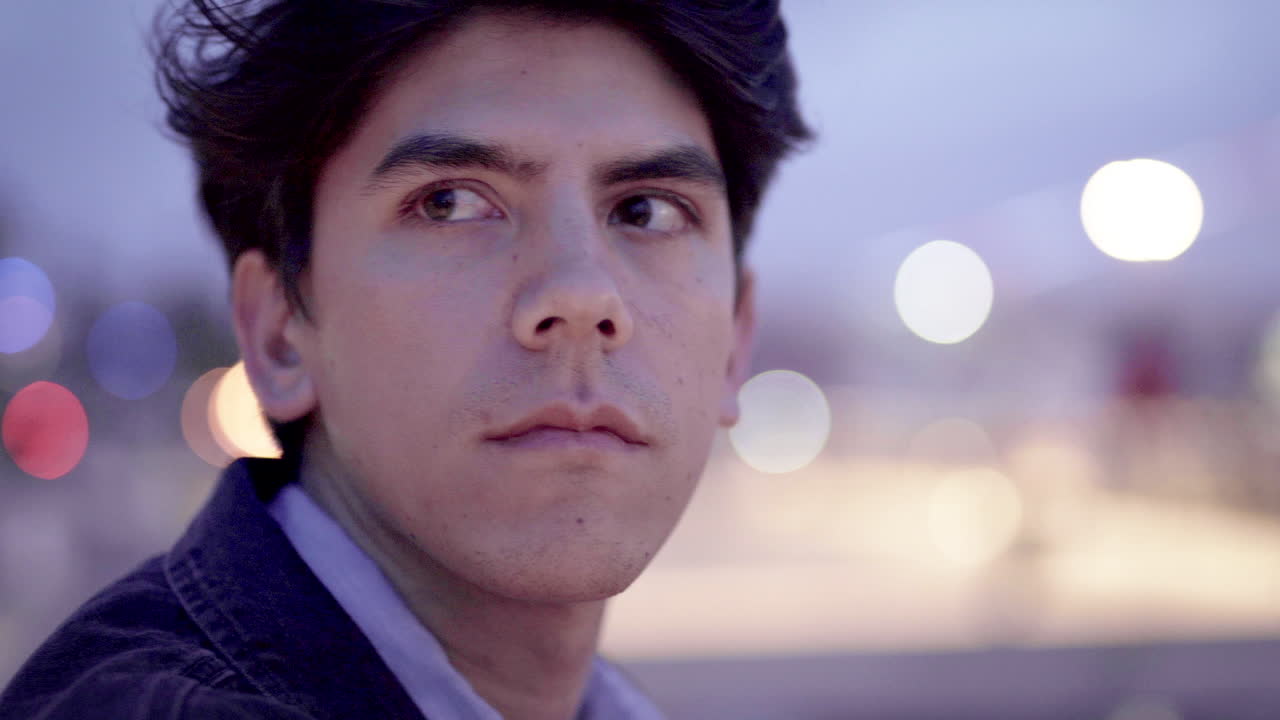 Portrait of a man with dark hair at night