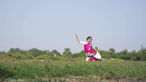 A-bharatnatyam-dancer-displaying-a-classical-bharatnatyam-pose-in-the-nature-of-Vadatalav-lake,-Pavagadh