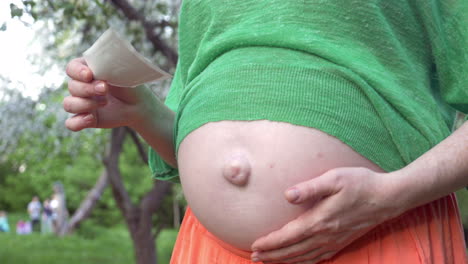 pregnant woman holding a sonogram image