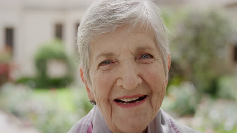 close-up-portrait-of-old-caucasian-woman-laughing-happy-looking-at-camera-enjoying-sunny-day-in-park