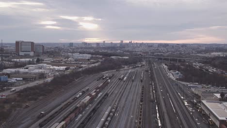 overview clip of sunrise over the horizon of a train yard