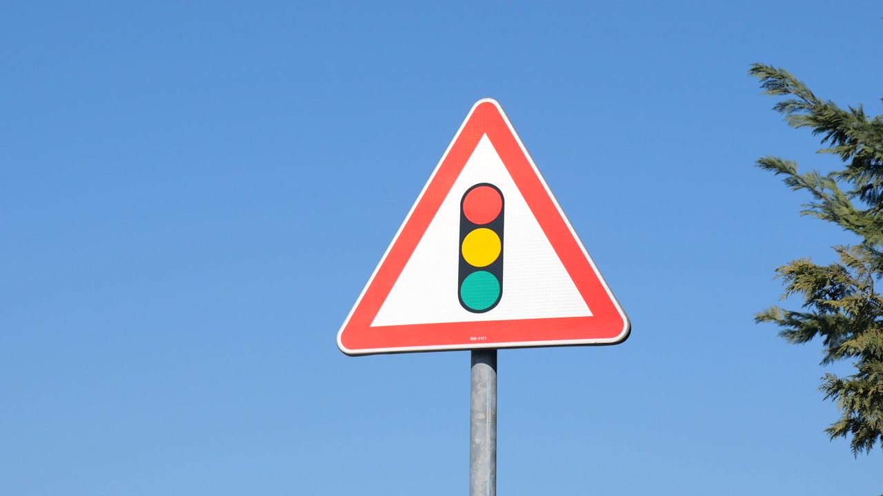 Triangular Traffic Light Warning Sign on a Clear Day