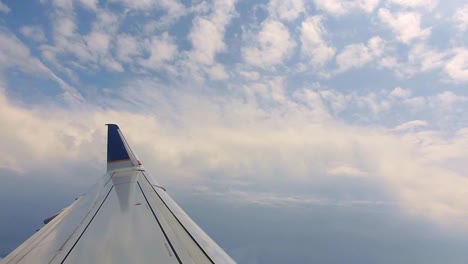 see a wing crossing the sky and clouds