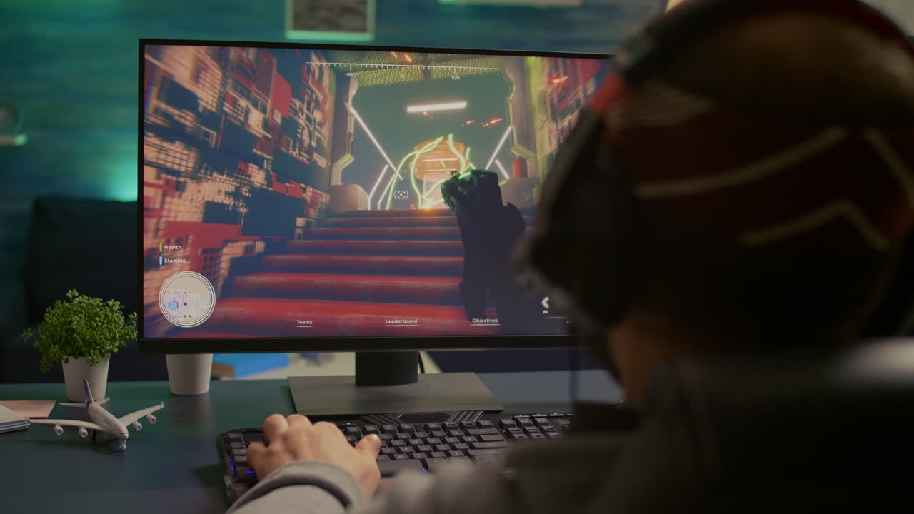 Back shot of pro gamer playing first person shooter game